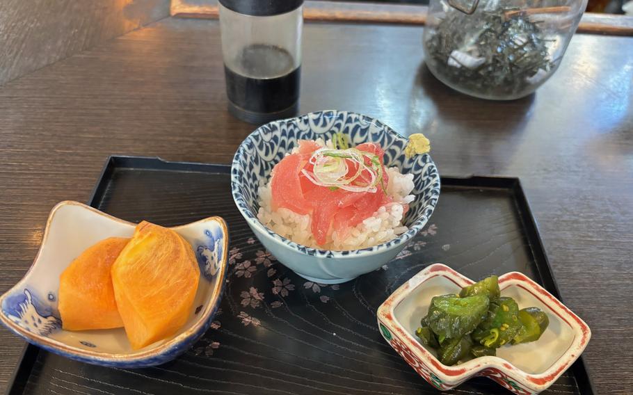 small bowls of tuna sashimi and rice, cut persimmon and pickles